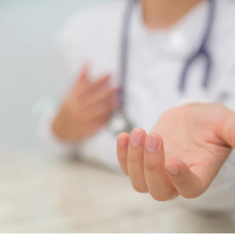 A doctor extends a hand to a patient, who has a numb hand, indicating a gesture of support and assistance.